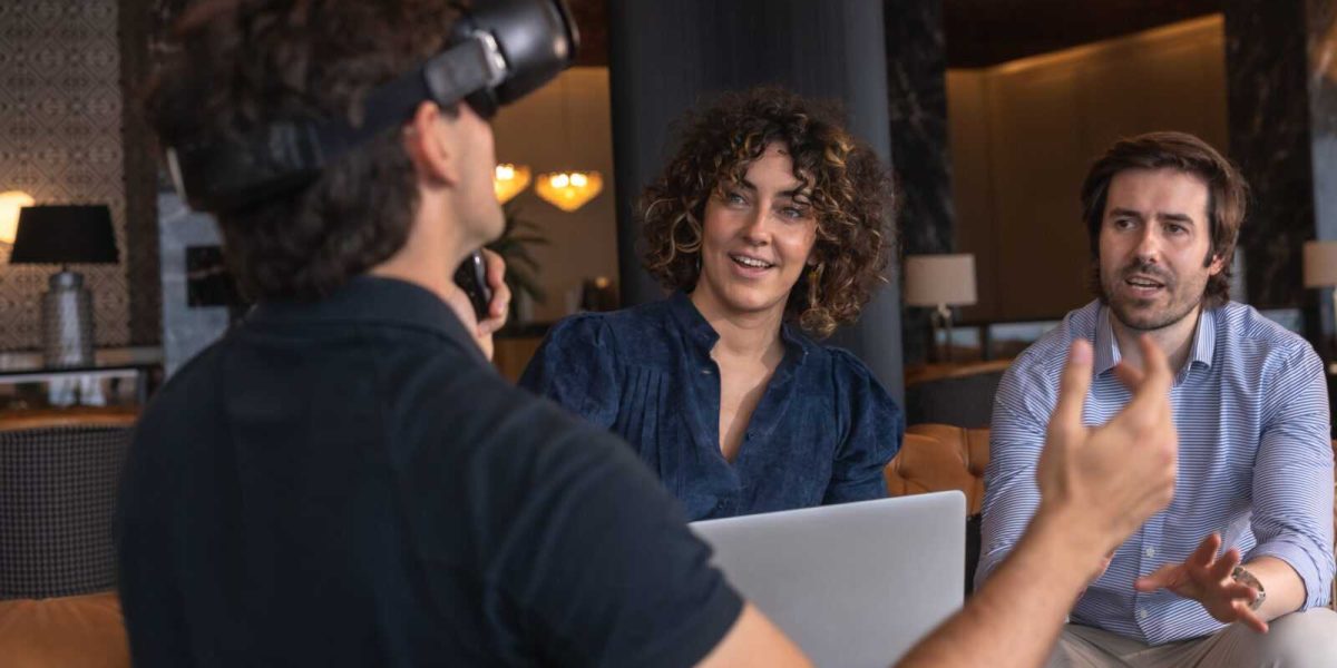 Business people using laptop and a virtual reality simulator