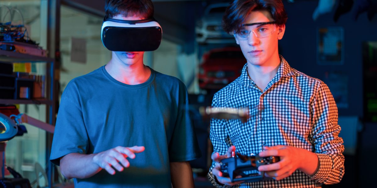 Teens remotely controlling robots in a laboratory